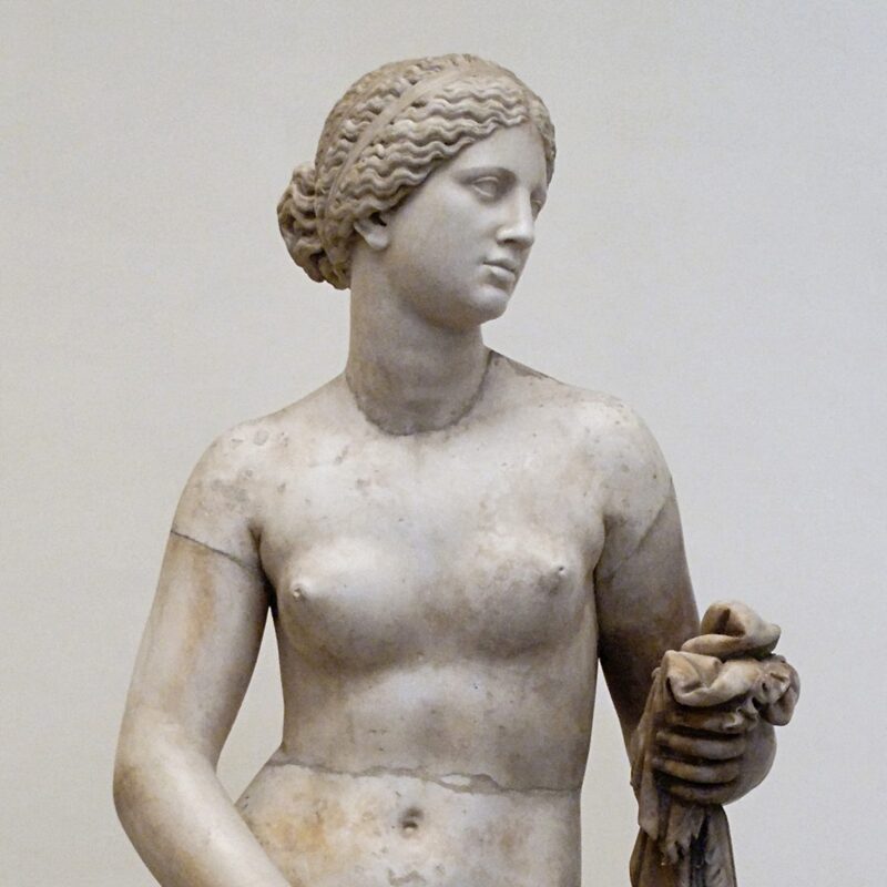 Aphrodite of Knidos
Another beautiful depiction of Aphrodite is this statue made by Praxiteles. 
Praxiteles is one of the most renowned artists of Ancient Greece. For this particular piece, Praxiteles was commissioned to create a statue for a temple in Kos. The artist made two versions. First, he presented this statue. Unfortunately, the citizens of Kos rejected it due to the nudity and took the clothed version he made.
After that, the nude statue was purchased by the people of Knidos. Currently, the original version of Aphrodite of Knidos is lost. The palace where it was housed burned down in 475. However, several copies do exist.
